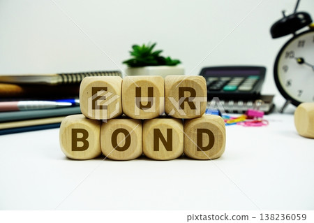 EUR Bond alphabet letters with calculator and alarm clock on white background EUR Bond alphabet letters with calculator and alarm clock on white background 138236059