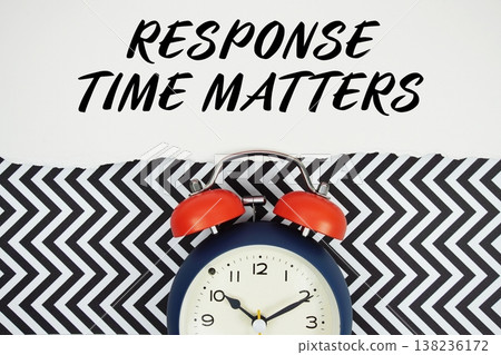 Response Time Matters text written on paper with alarm clock on black chevron background 138236172