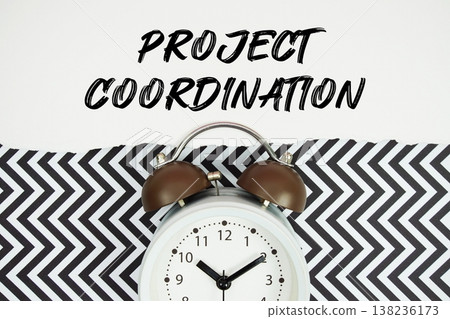 Project Coordination text written on paper with alarm clock on black chevron background Project Coordination text written on paper with alarm clock on black chevron background 138236173