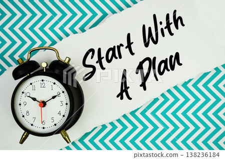Start With A Plan text written on paper rip with alarm clock flat lay on turquoise chevron background Start With A Plan text written on paper rip with alarm clock flat lay on turquoise chevron background 138236184