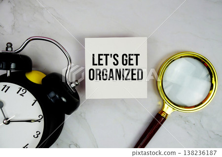 Let's Get Organized text with sticky note and alarm clock flat lay on marble background Let's Get Organized text with sticky note and alarm clock flat lay on marble background 138236187