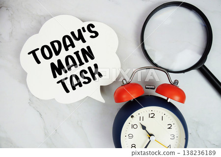Today's Main Task text with magnifying glass and alarm clock on marble background Today's Main Task text with magnifying glass and alarm clock on marble background 138236189