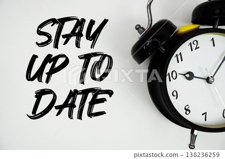 Stay Up To Date text with alarm clock flat lay on white background 138236259