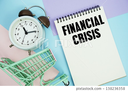 Financial Crisis text written on notepad with alarm clock and trolley shopping cart 138236358