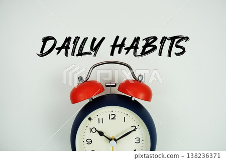 Daily Habits text with alarm clock flat lay on white background Daily Habits text with alarm clock flat lay on white background 138236371