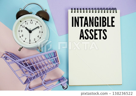 Intangible Assets text written on notepad with alarm clock and trolley shopping cart Intangible Assets text written on notepad with alarm clock and trolley shopping cart 138236522