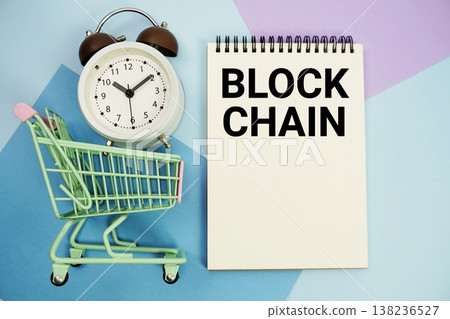 Block Chain text written on notepad with alarm clock and trolley shopping cart 138236527