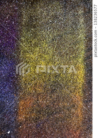 Abstract background of coloured vibrant chalk dust on black background chalky grit texture 138236577