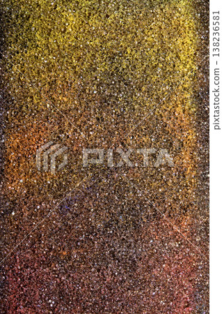 Abstract background of coloured vibrant chalk dust on black background chalky grit texture 138236581