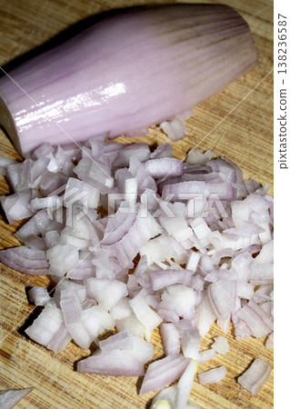 Close up of a chopped shallot onion on a wooden chopping board Close up of a chopped shallot onion on a wooden chopping board 138236587