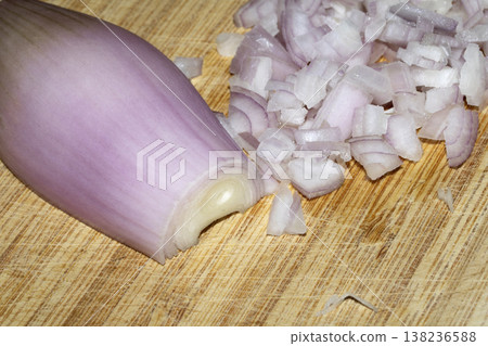 Close up of a chopped shallot onion on a wooden chopping board Close up of a chopped shallot onion on a wooden chopping board 138236588