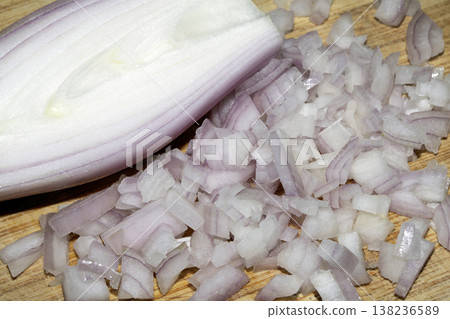 Close up of a chopped shallot onion on a wooden chopping board Close up of a chopped shallot onion on a wooden chopping board 138236589