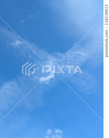 Beautiful blue summer air with fluffy white clouds and chem trail lines across the sky 138236613