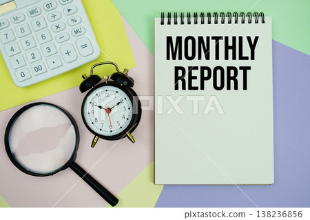 Monthly Report text with calculator, alarm clock and magnifying glass Monthly Report text with calculator, alarm clock and magnifying glass 138236856