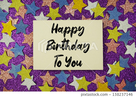 "Happy Birthday to you" message on paper card with purple background with colorful glitter stars "Happy Birthday to you" message on paper card with purple background with colorful glitter stars 138237146