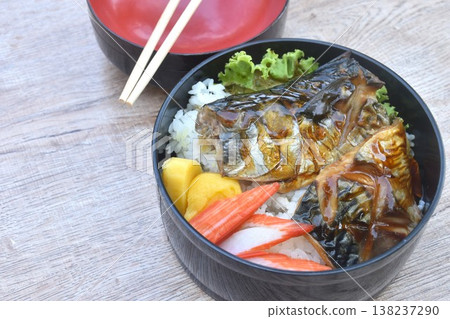 grilled saba fish or mackerel on rice topping sweet egg and crab stick couple lettuce salad bento set in lunch box on table grilled saba fish or mackerel on rice topping sweet egg and crab stick couple lettuce salad bento set in lunch box on table 138237290