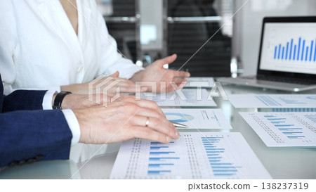 Business executive hands on contract paper with pen, preparing to sign an agreement during a meeting, representing corporate deal negotiation and legal process 138237319