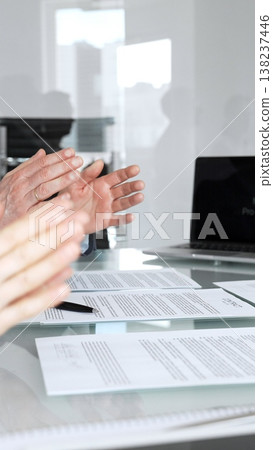 Group of business professionals in a modern office meeting clapping hands and celebrating success after signing a new contract. Concept of teamwork, achievement, partnership, and corporate success Group of business professionals in a modern office meeting clapping hands and celebrating success after signing a new contract. Concept of teamwork, achievement, partnership, and corporate success 138237446