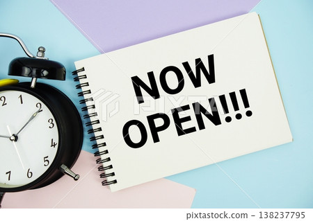 Now Open text written on notepad with alarm clock flat lay on multicolor pastel background Now Open text written on notepad with alarm clock flat lay on multicolor pastel background 138237795