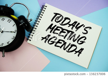 Today's Meeting Agenda text written on notepad with alarm clock flat lay on multicolor pastel background 138237806