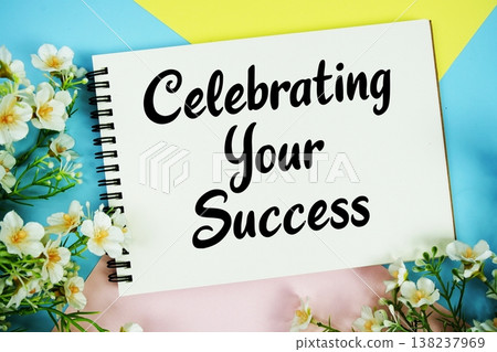 Celebrating Your Success text written on notepad with flowers decorations flat lay on multicolor pastel background 138237969