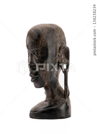 Dark wooden tribal head, calm and thoughtful, ethnic art, cultural artifact 138238234