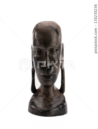 Abstract tribal head sculpture in dark wood, minimalist and serene Abstract tribal head sculpture in dark wood, minimalist and serene 138238236