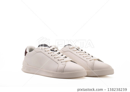 Minimalist white low-top sneakers on plain white background Minimalist white low-top sneakers on plain white background 138238239
