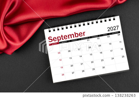 September 2027 Monthly desk calendar with red silk on black leather background. 138238263