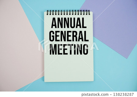 Annual General Meeting text written on notepad flat lay on multicolor pastel background 138238287