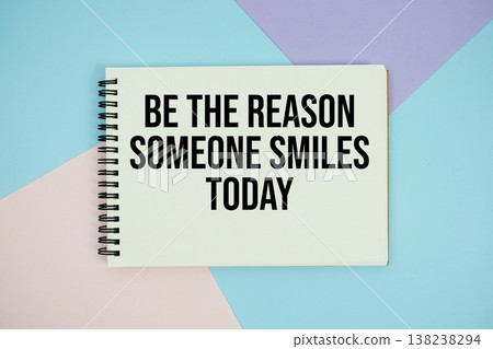 Be The Reason Someone Smiles Today text written on notepad flat lay on multicolor pastel background 138238294