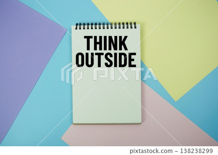 Think Outside text written on notepad flat lay on multicolor pastel background 138238299