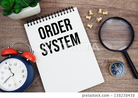 Order System text written on notepad with alarm clock, compass and magnifying glass flat lay on wooden background 138238438