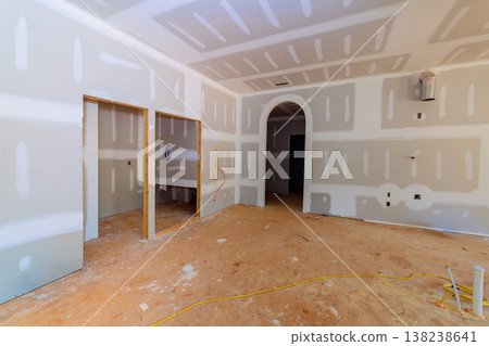 Workers prepare space for drywall installation, wall finishing in home renovation. 138238641