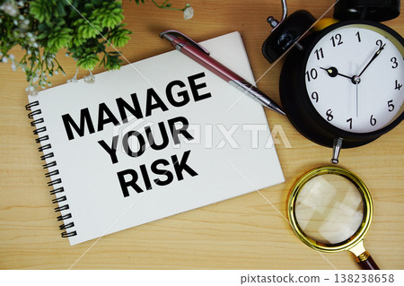 Manage Your Risk text written on notepad with alarm clock and magnifying glass flat lay on wooden background Manage Your Risk text written on notepad with alarm clock and magnifying glass flat lay on wooden background 138238658