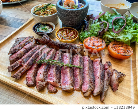 Perfect Grilled medium rare Ribeye Steak Platter with Sides and thai style sauce 138238949