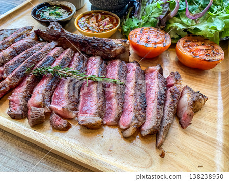 Perfect Grilled medium rare Ribeye Steak Platter with Sides and thai style sauce 138238950