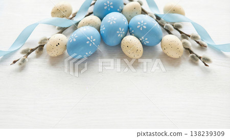 Easter eggs with floral patterns on white background with blue ribbons and catkins 138239309