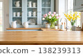 Blurred kitchen interior with wooden countertop and flowers Blurred kitchen interior with wooden countertop and flowers 138239313