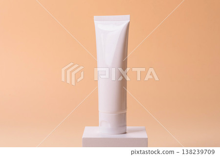 A white empty plastic or aluminum tube for cream, paste as a mockup. An empty cosmetic tube mockup A white empty plastic or aluminum tube for cream, paste as a mockup. An empty cosmetic tube mockup 138239709
