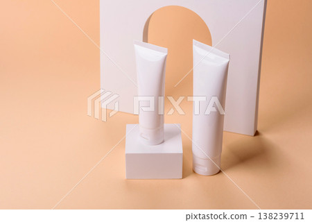 A white empty plastic or aluminum tube for cream, paste as a mockup. An empty cosmetic tube mockup A white empty plastic or aluminum tube for cream, paste as a mockup. An empty cosmetic tube mockup 138239711