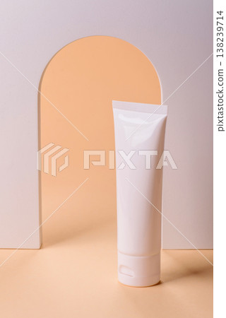 A white empty plastic or aluminum tube for cream, paste as a mockup. An empty cosmetic tube mockup 138239714