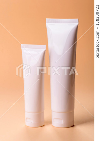 A white empty plastic or aluminum tube for cream, paste as a mockup. An empty cosmetic tube mockup A white empty plastic or aluminum tube for cream, paste as a mockup. An empty cosmetic tube mockup 138239723