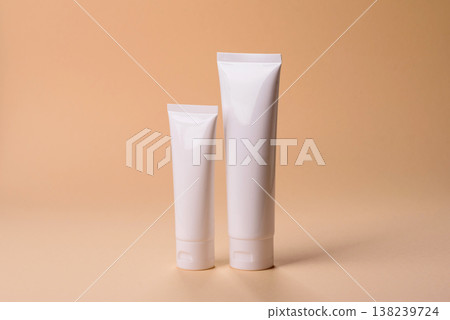 A white empty plastic or aluminum tube for cream, paste as a mockup. An empty cosmetic tube mockup 138239724