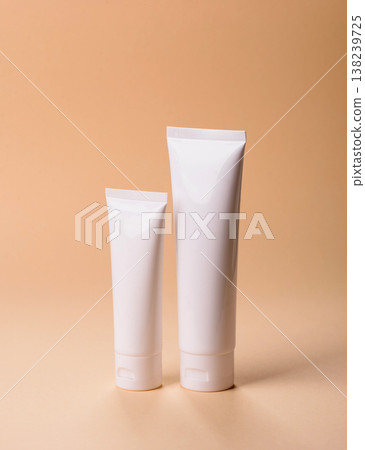 A white empty plastic or aluminum tube for cream, paste as a mockup. An empty cosmetic tube mockup 138239725