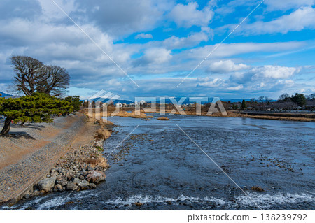 Japan: Kamo River and pine trees in Arashiyama, Kyoto, and Togetsukyo Bridge 138239792