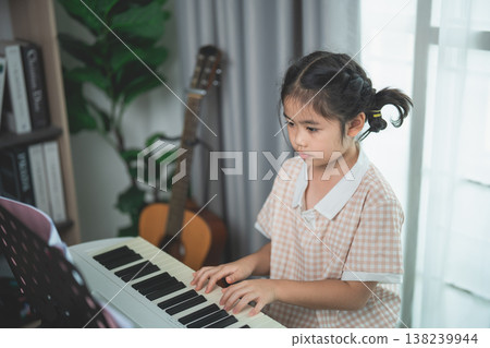 Young girl with braided hair playing piano indoors, focused expression, soft lighting, musical setting, cozy home atmosphere, childhood creativity and learning Young girl with braided hair playing piano indoors, focused expression, soft lighting, musical setting, cozy home atmosphere, childhood creativity and learning 138239944