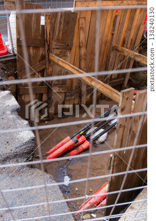 black plastic pipes in ground for drainage of sewage rainwater, lying in trench of sand. black plastic pipes in ground for drainage of sewage rainwater, lying in trench of sand. 138240130