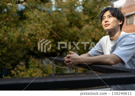 A young man is deep in thought outdoors. A young man is deep in thought outdoors. 138240611