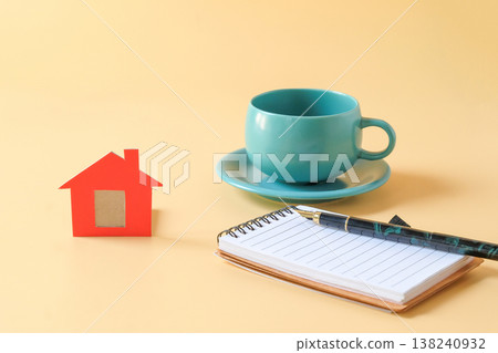 Small red dollhouse with booknote and pen. 138240932